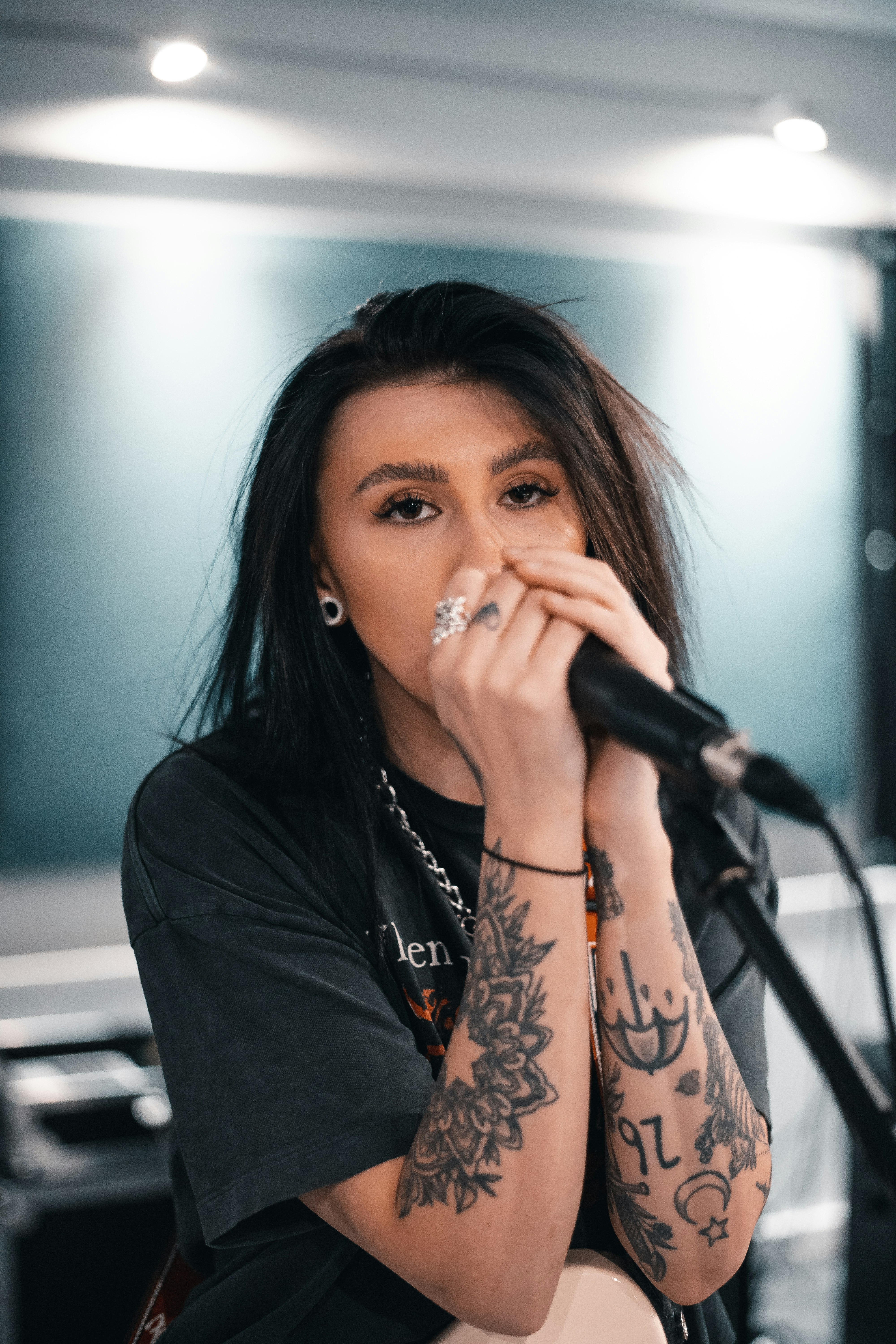 woman in black long sleeve shirt holding microphone